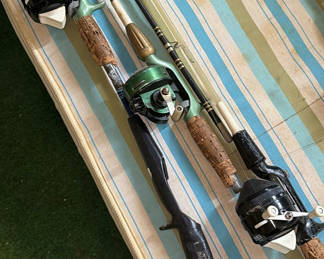 Lot 66: Three fishing rods with reels