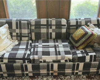Lot 2: Plaid sleeper sofa with cushions and floral sheet