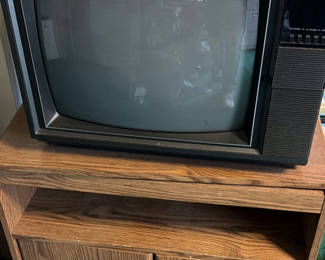 Lot 218: Vintage RCA XL-100 CRT television on wood media cabinet
