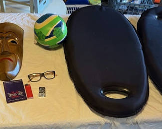 Lot 30: Assorted items: carved wooden mask, barometer, books, glasses, lighter, cushions, ball and circular object
