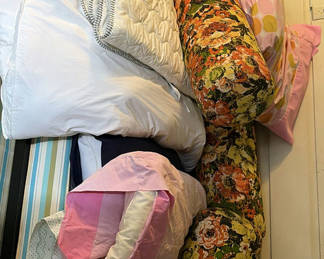Lot 69: Assorted bedding textiles: pillows, bolsters, and blankets