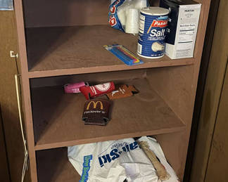 Lot 60: Shelf with salt, paper towels, condiments, and snack wrappers