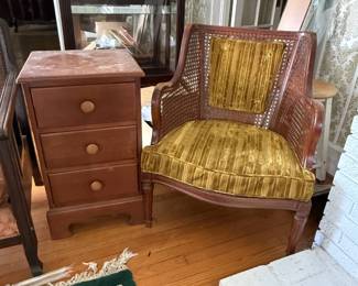 Nightstand with drawers and cane back chair with cushions