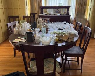 various glassware and china. large 8 person table with chairs. leather table top cover.