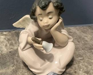 This is the "Heavenly Chimes" (No. 5723) glossy porcelain figurine manufactured by the renowned Spanish brand Lladró.