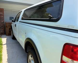 White Ford F-150 Pickup Truck with Camper Shell