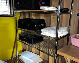 Luggage on a 5-tier metal wire shelving unit
