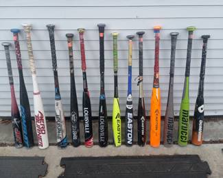 Large selection of baseball bats and other equipment.