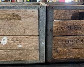 Two wooden Borden’s milk crates
