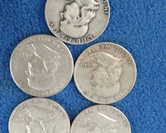 Lot 31. Five Benjamin Franklin silver half-dollars