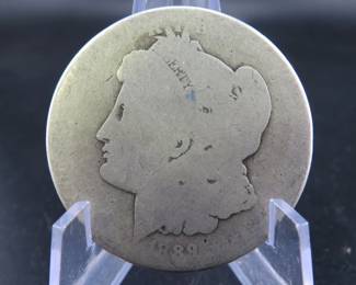 Lot 243. 1889 O Morgan silver dollar