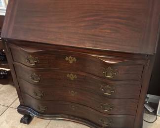 Vintage mahogany Maddux, Chippendale style secretary, desk featuring a serpentine, front ball and claw feet