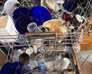 Dishwasher full of clean stemware and glassware.