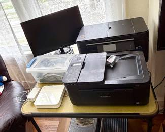 This Canon PIXMA TR4520 printer features wireless functionality and is capable of printing, scanning, copying, and faxing;  Brother MFC-J5620DW printer features a 3.7-inch color touchscreen display.It is part of the "Business Smart Plus" series with touchscreen that allows for navigation to various functions like scanning, copying, and cloud connectivity; ASUS monitor;  Apple AirPort Extreme Base Station