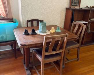 Vintage oak draw-leaf dining table features a panelled top and trestle-style supports with splayed feet