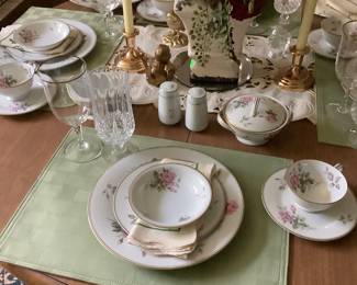 The table with the China and other accessories. This is the round maple table with 4 chairs.