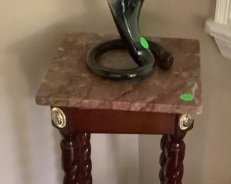 Mahogany stand with marble top.