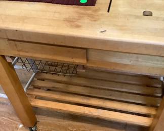 Butcher block cart with bottom shelf.