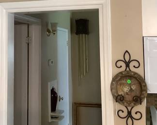 Metal wall hanging over door.