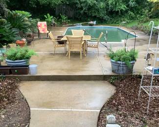Out by the pool js a beige metal table and four chairs. Price: $145.00