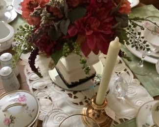 The center piece on the table with runner and candle holders.