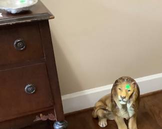 The ceramic lion laying down. Price: $50.00