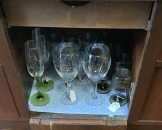 Crystal glasses in middle of buffet. Has pull down door.