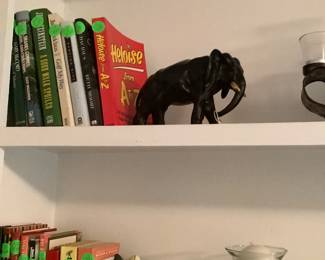 Candle holders, elephant, book ends in book shelf.