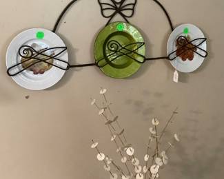 Metal Chief wall hanging with plates.