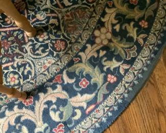 The round rug under the table. Price: 160.00