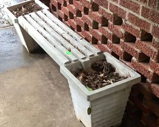 Bench with flower pots on each end.