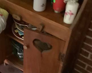 Bottom of little oak cabinet with hearts. Price: $28.00