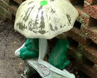 Cement frogs with umbrella.
