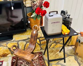 birthing chair, rugs, bell and howell projector, movie camera
