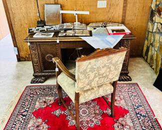 persian rug, ornate desk and chair, military scrapbooks and photo albums