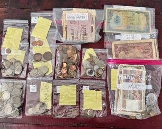 coins and paper currency from all over the world, some silver