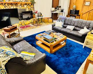 vibrant blue rug, leather sofa and loveseat, 80s contemporary coffee table