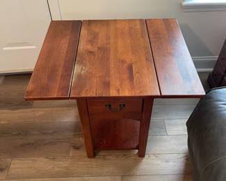 M28 - $20. Drop leaf side table. Measures 30" wide with leaves out. 15" wide when leaves are down. 25" deep x 25.25" tall. Sturdy! Great project piece. Does have wear on the top and water ring on the shelf.