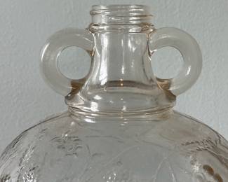 M19 - $20. Garrett's 1 Gallon American Wine. The glass is a faint peach color. Measures 6.75" wide x 5.25" x 11.5" tall.