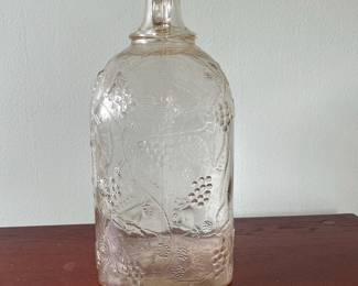 M19 - $20. Garrett's 1 Gallon American Wine. The glass is a faint peach color. Measures 6.75" wide x 5.25" x 11.5" tall.