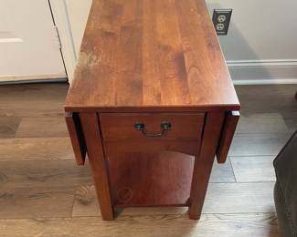 M28 - $20. Drop leaf side table. Measures 30" wide with leaves out. 15" wide when leaves are down. 25" deep x 25.25" tall. Sturdy! Great project piece. Does have wear on the top and water ring on the shelf.