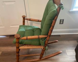 M24 - $40. Wooden Rocking Chair with Rush Seat. Green Cushion is removeable. Measures 24" wide x 30.5" deep x 37.5" tall. Floor to seat is 17".