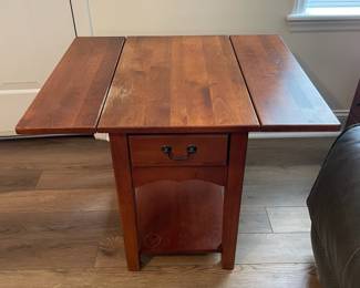 M28 - $20. Drop leaf side table. Measures 30" wide with leaves out. 15" wide when leaves are down. 25" deep x 25.25" tall. Sturdy! Great project piece. Does have wear on the top and water ring on the shelf.