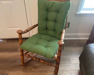 M24 - $40. Wooden Rocking Chair with Rush Seat. Green Cushion is removeable. Measures 24" wide x 30.5" deep x 37.5" tall. Floor to seat is 17".