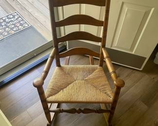 M24 - $40. Wooden Rocking Chair with Rush Seat. Green Cushion is removeable. Measures 24" wide x 30.5" deep x 37.5" tall. Floor to seat is 17".