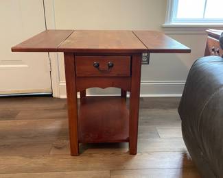 M28 - $20. Drop leaf side table. Measures 30" wide with leaves out. 15" wide when leaves are down. 25" deep x 25.25" tall. Sturdy! Great project piece. Does have wear on the top and water ring on the shelf.