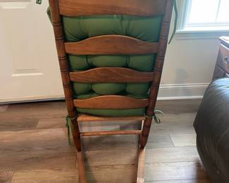 M24 - $40. Wooden Rocking Chair with Rush Seat. Green Cushion is removeable. Measures 24" wide x 30.5" deep x 37.5" tall. Floor to seat is 17".