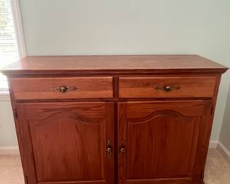 M12 - $75. Buffet / Server in Cedar Finish. C.J. Woodmaster. Very good condition. Measures 49.25" x 17.5" x 34" tall.