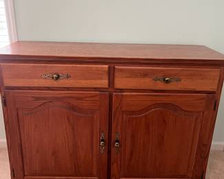 M12 - $75. Buffet / Server in Cedar Finish. C.J. Woodmaster. Very good condition. Measures 49.25" x 17.5" x 34" tall.