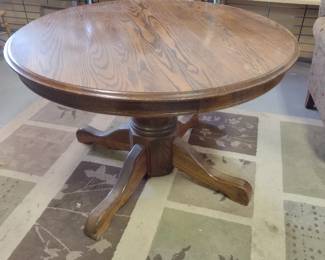 Round solid wood kitchen table, seats four comfortably